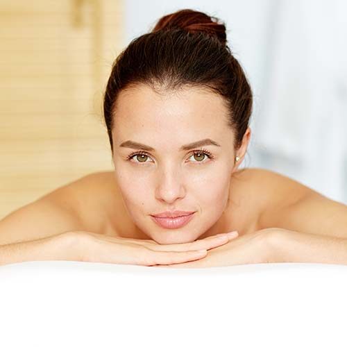 Relaxed female waiting for massage while lying in spa salon